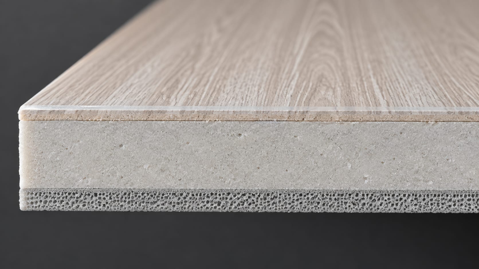 Corte transversal de una tabla de piso SPC con capa de uso, film decorativo, núcleo de piedra y base acústica IXPE